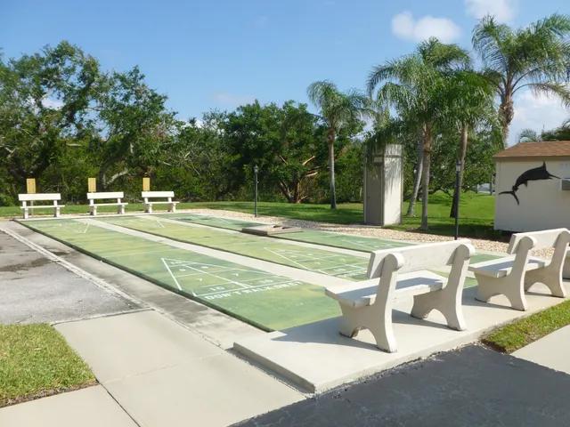 a view of a patio with a table and chairs under an umbrella