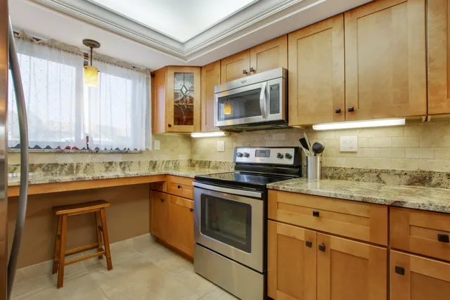 a kitchen with stainless steel appliances granite countertop a sink and cabinets