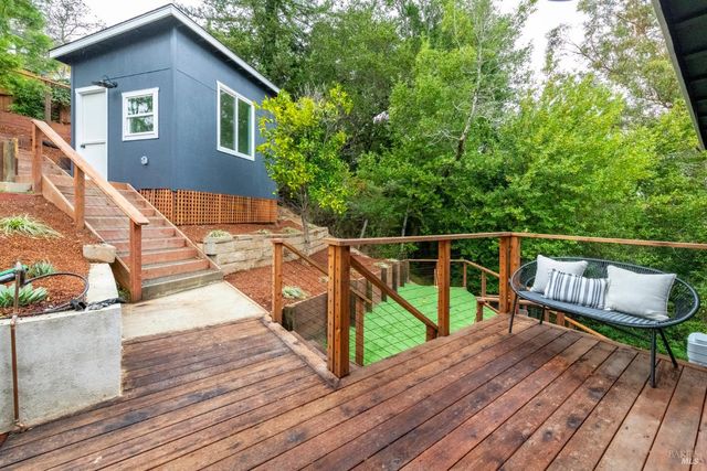 a view of a patio with table and chairs under an umbrella