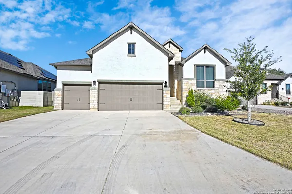 a view of garage yard and front view of a house