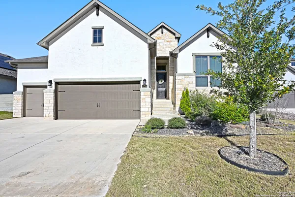 a view of a house with a yard and garage