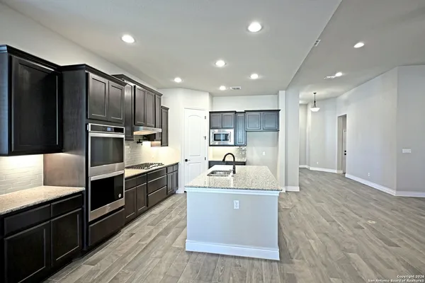 a large kitchen with stainless steel appliances kitchen island granite countertop a large counter top stainless steel appliances and cabinets