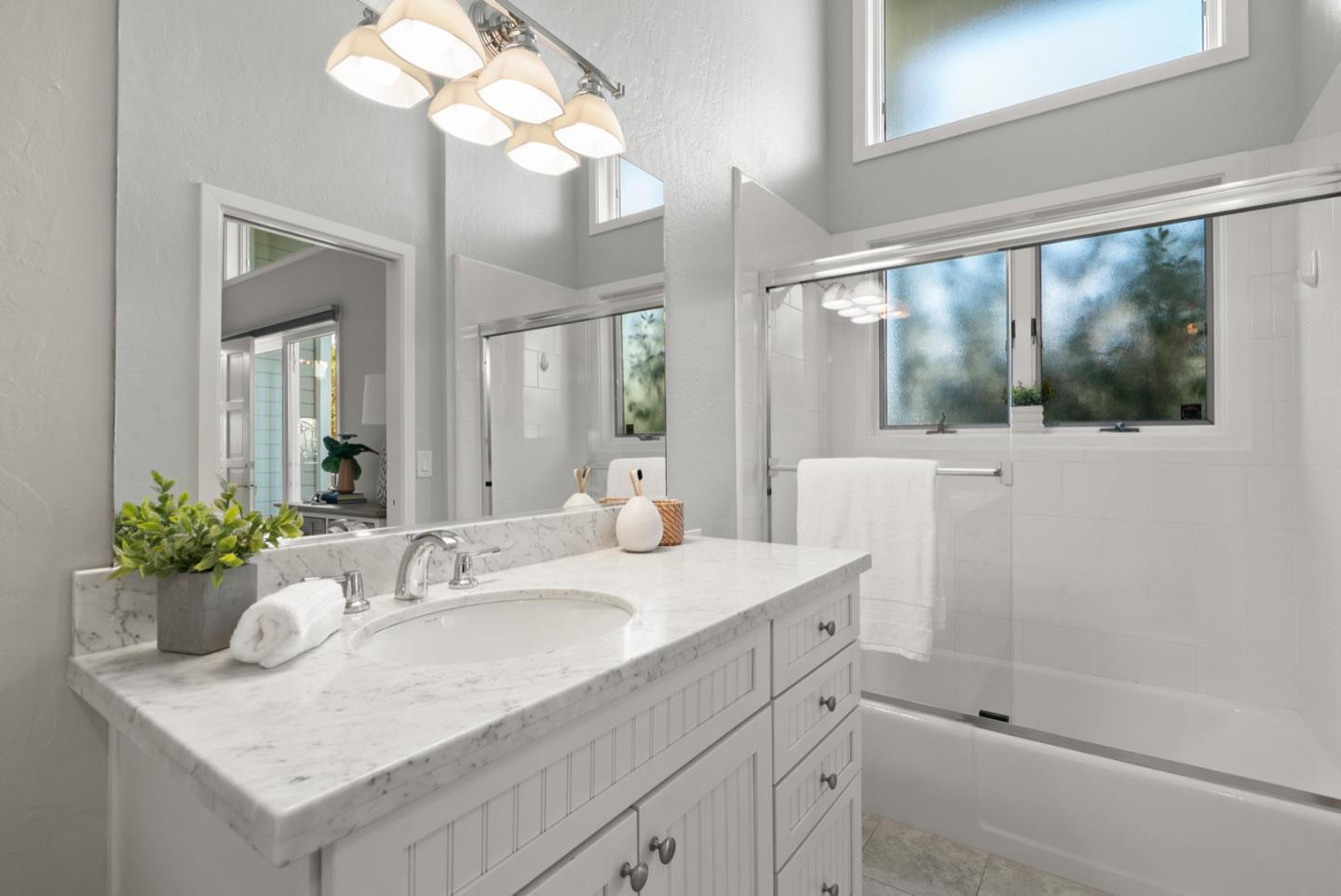 152 Frederick Street Santa Cruz, CA 95062 - Photo 12 of 64 a bathroom with a sink a large mirror and a shower