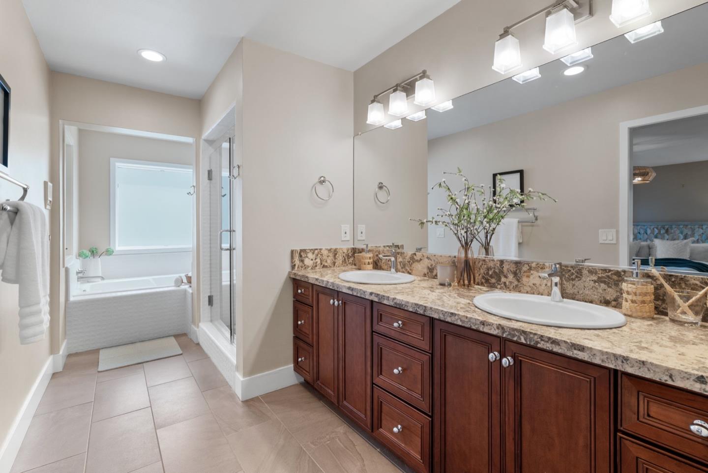 152 Frederick Street Santa Cruz, CA 95062 - Photo 20 of 64 a bathroom with a granite countertop double vanity sink a large mirror and a bathtub
