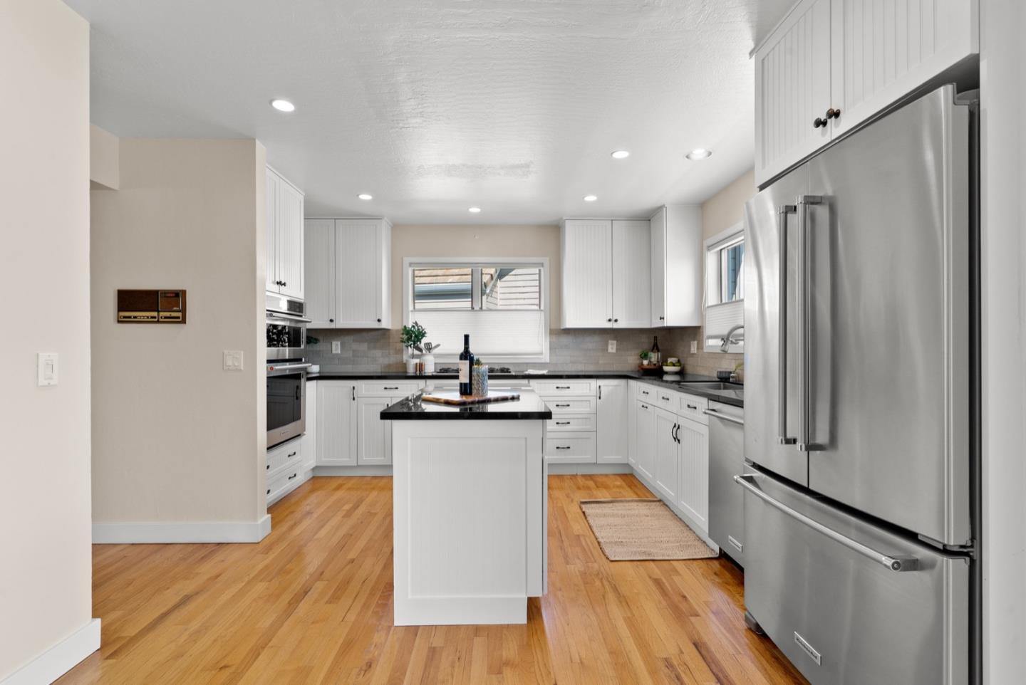 152 Frederick Street Santa Cruz, CA 95062 - Photo 3 of 64 a kitchen with white cabinets stainless steel appliances and a refrigerator