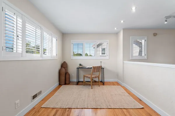 a dining room with furniture and wooden floor