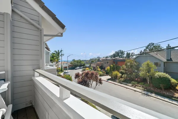 a kitchen with granite countertop stainless steel appliances a refrigerator cabinets and wooden floor