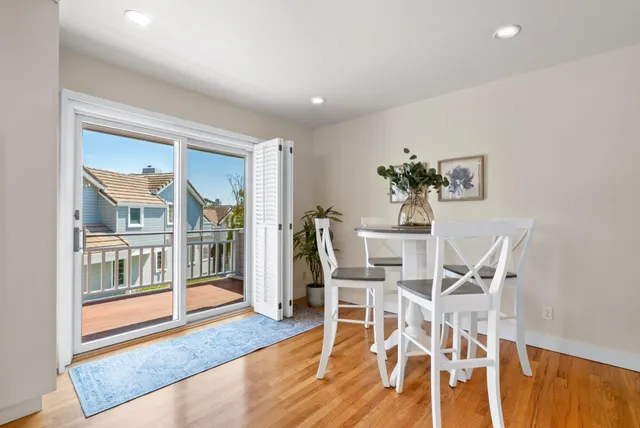a kitchen with white cabinets and appliances