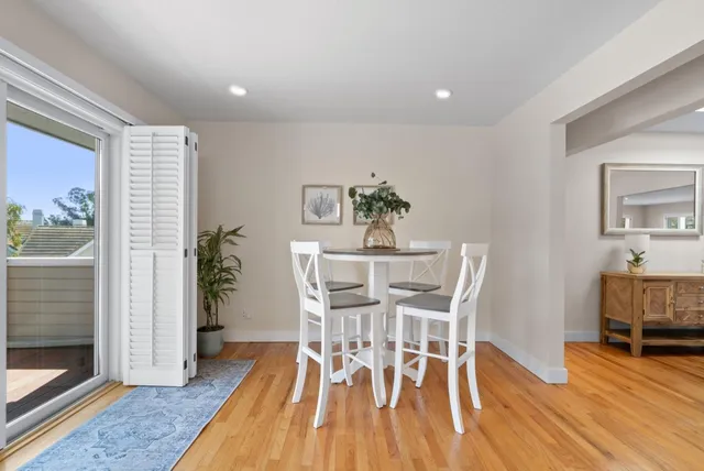 a kitchen with granite countertop white cabinets and white stainless steel appliances