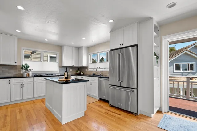 a view of a room with wooden floor and a bathroom