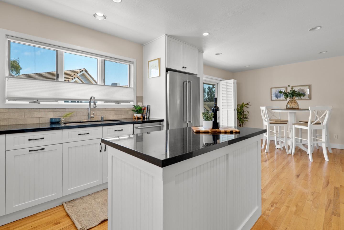 152 Frederick Street Santa Cruz, CA 95062 - Photo 44 of 64 a kitchen with stainless steel appliances granite countertop a stove top oven a sink a dining table and chairs