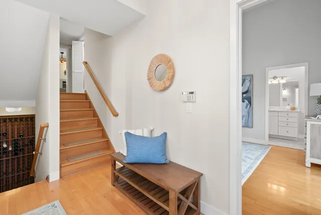 a view of a hallway with entryway wooden floor and front door
