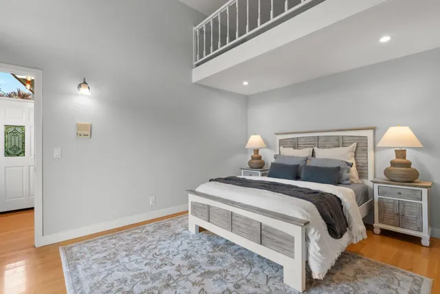 a bedroom with a bed dresser and a flat tv screen