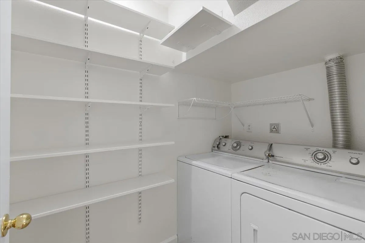8973 Arlingdale Way Spring Valley, CA 91977 - Photo 13 of 24 a utility room with cabinets washer and dryer