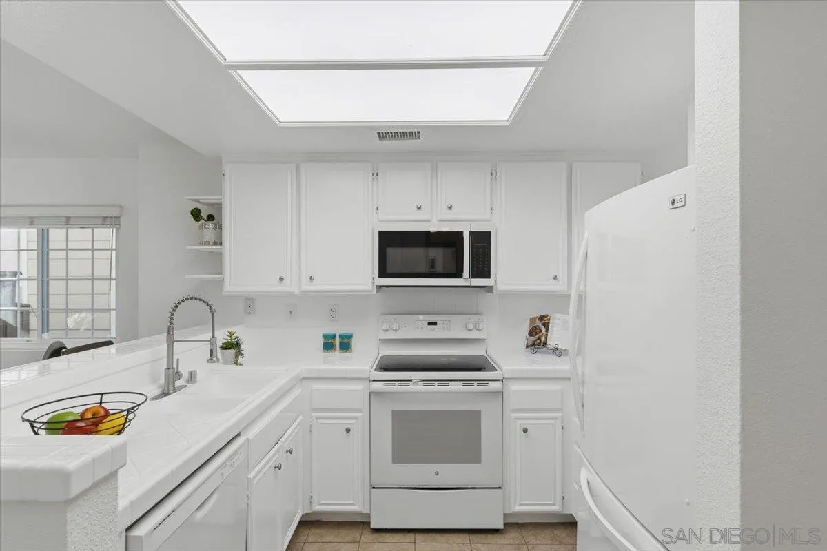 8973 Arlingdale Way Spring Valley, CA 91977 - Photo 2 of 24 a kitchen with stainless steel appliances a stove microwave and sink