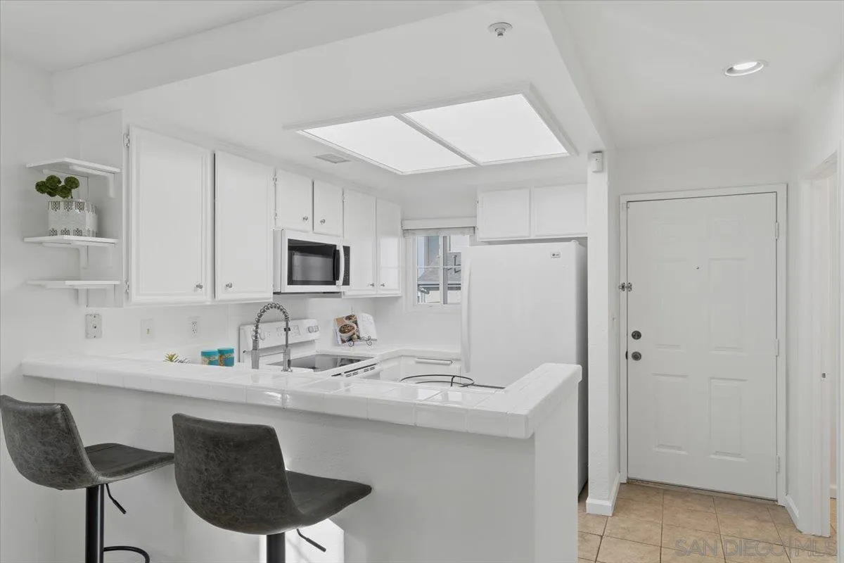 8973 Arlingdale Way Spring Valley, CA 91977 - Photo 3 of 24 a kitchen with a sink cabinets and refrigerator