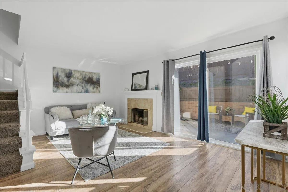8973 Arlingdale Way Spring Valley, CA 91977 - Photo 4 of 24 a living room with furniture a fireplace and a potted plant