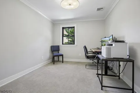 a workspace room with furniture and a window