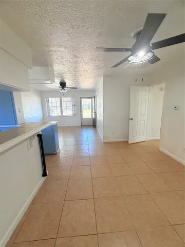 a view of hallway with stairs and wooden floor