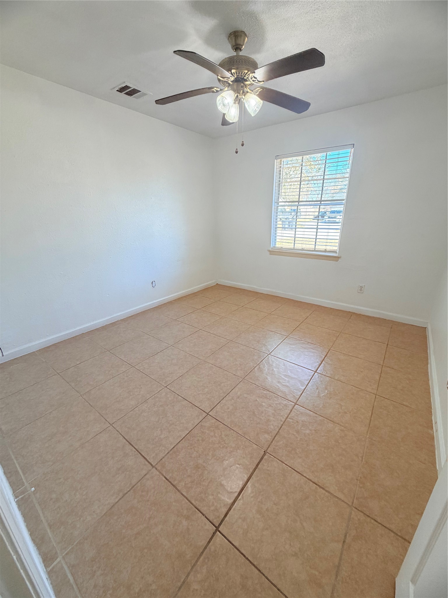207 Inwood Lane Highlands, TX 77562 - Photo 7 of 20 an empty room with windows and ceiling fan
