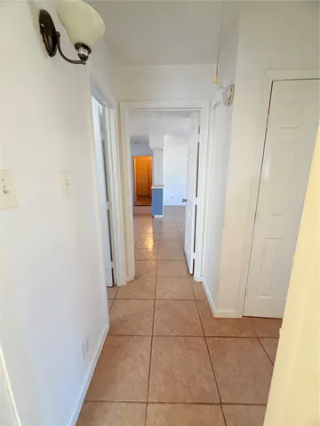 a view of a hallway to rooms and stairs