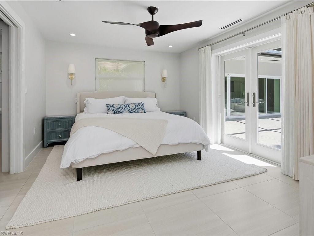1390 Mandarin Road Naples, FL 34102 - Photo 32 of 50 Recessed lighting, ceiling fan, wall sconces, white tile flooring, and double patio doors