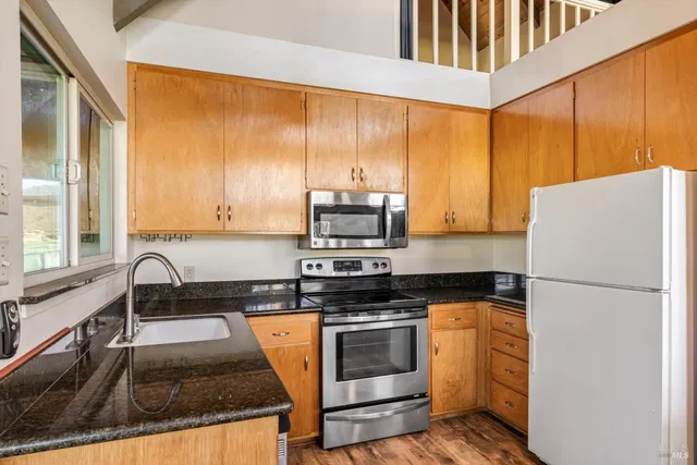 a view of a living room and kitchen