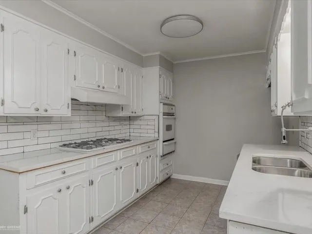 a kitchen with a sink and cabinets
