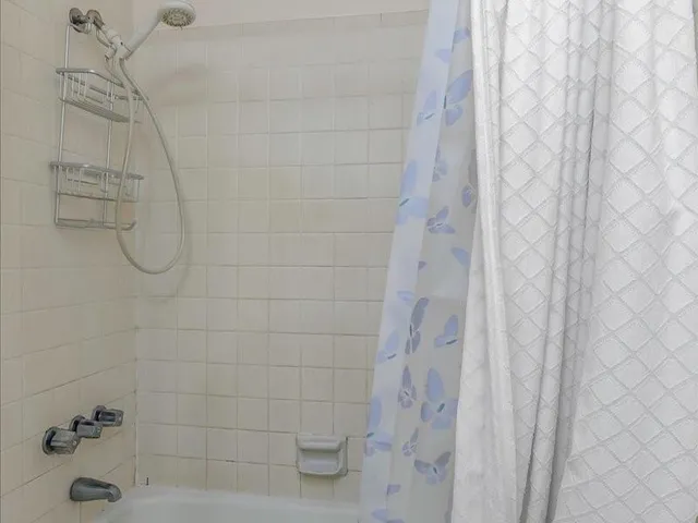 a view of an empty room with a ceiling fan
