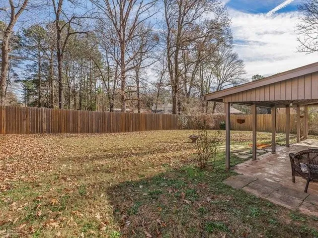 a view of a patio with table and chairs