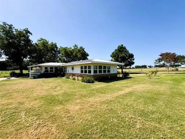 a front view of a building with a garden