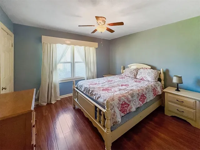 a bedroom with a bed and a large window