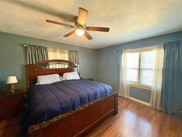 a bedroom with a large bed and a window