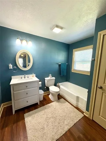 a living room with furniture and a mirror