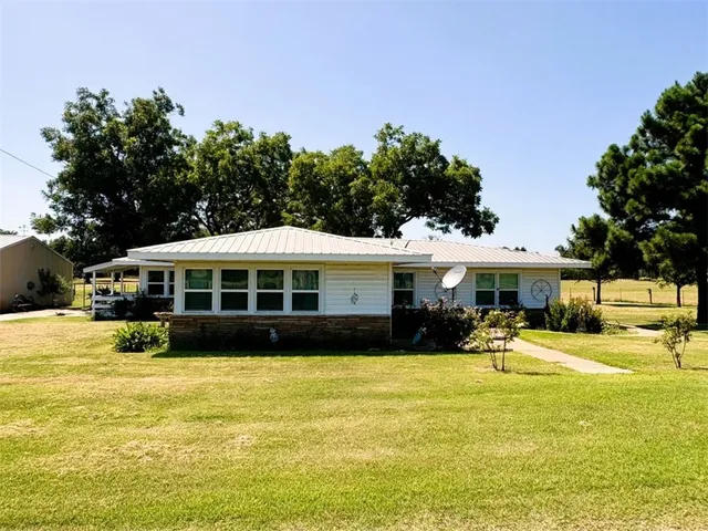 a front view of a house with a yard table and chairs