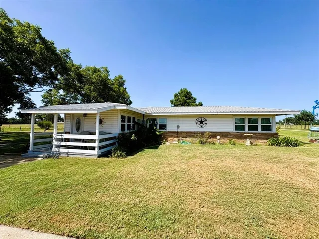 a view of house with outdoor space and swimming pool