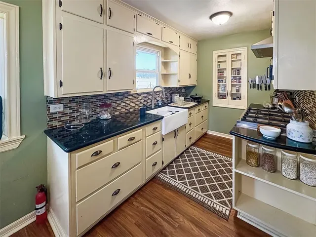 a kitchen with stainless steel appliances kitchen island granite countertop a stove and a cabinets