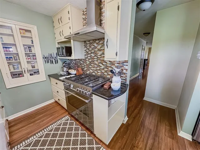a kitchen with stainless steel appliances granite countertop a stove and a refrigerator