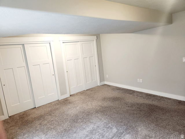 36 West Syracuse Road Vineyard, UT 84059 - Photo 53 of 56 Room featuring white sliding closet doors, light gray wall paint, white baseboards, and neutral-toned carpet flooring