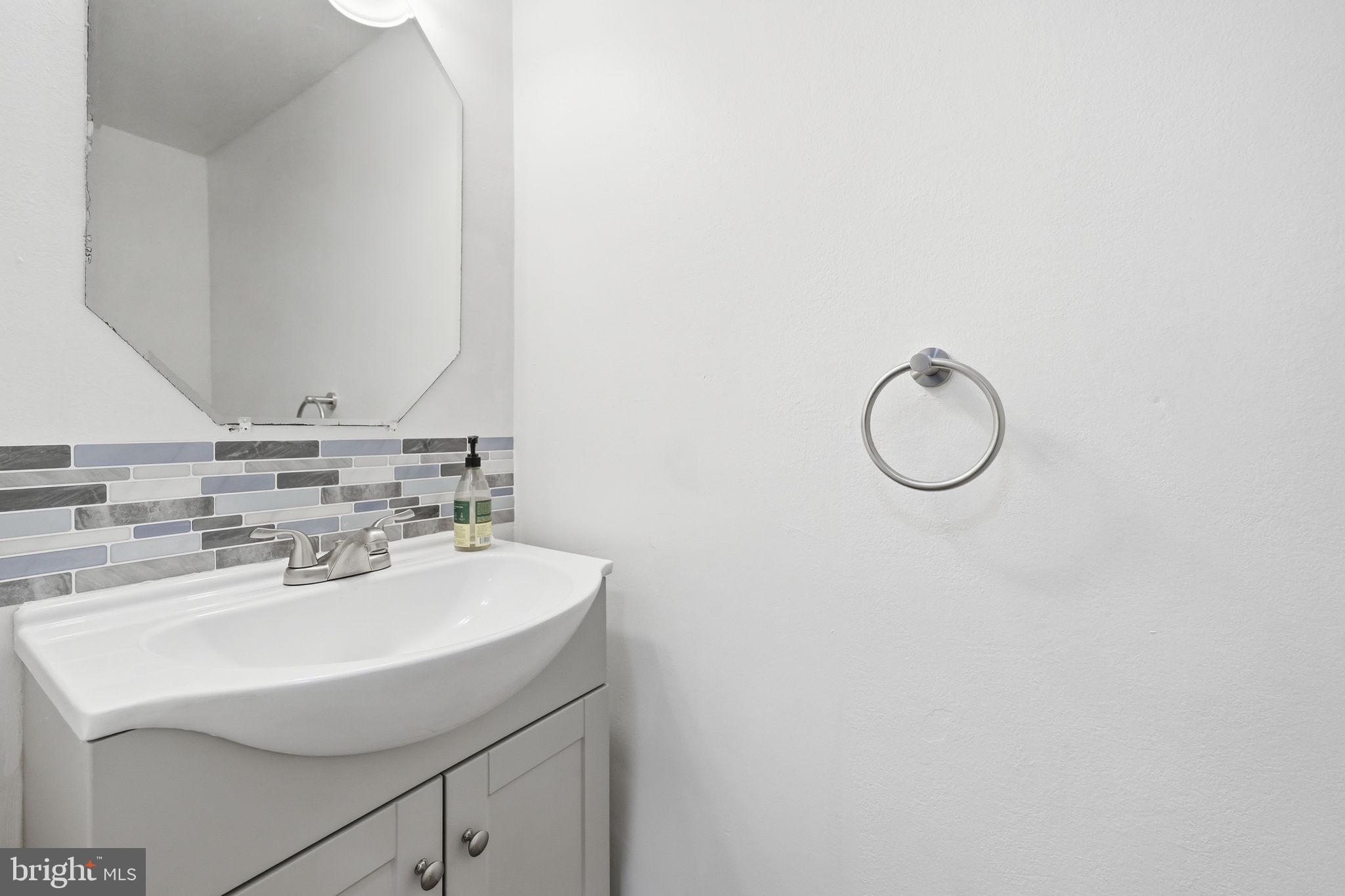 8260 Getty Court Springfield, VA 22153 - Photo 7 of 31 a bathroom with a sink and a mirror