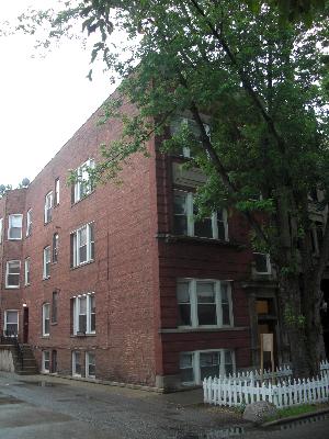 a view of a brick building next to a yard
