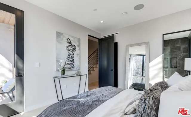 a bedroom with a bed and a mirror