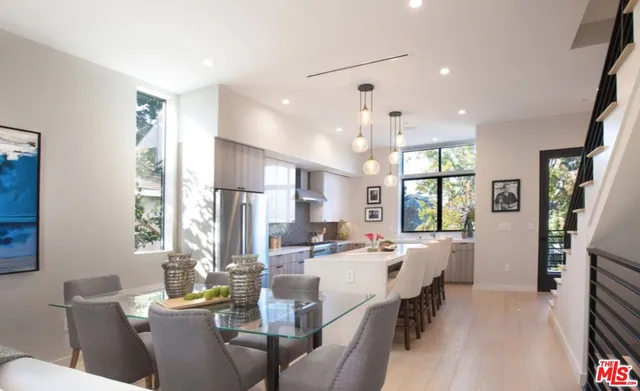 a view of a dining room with furniture window and wooden floor