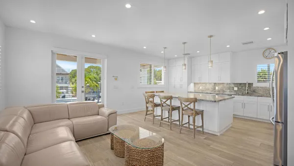 a living room with furniture and a wooden floor