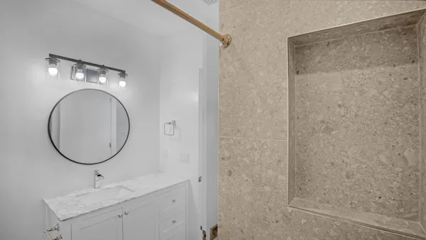 a bathroom with a glass shower door
