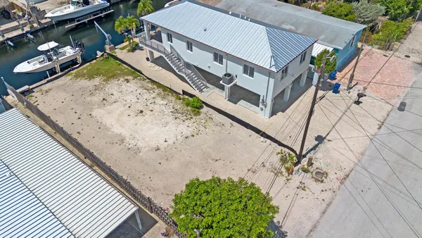 an aerial view of residential building and lake