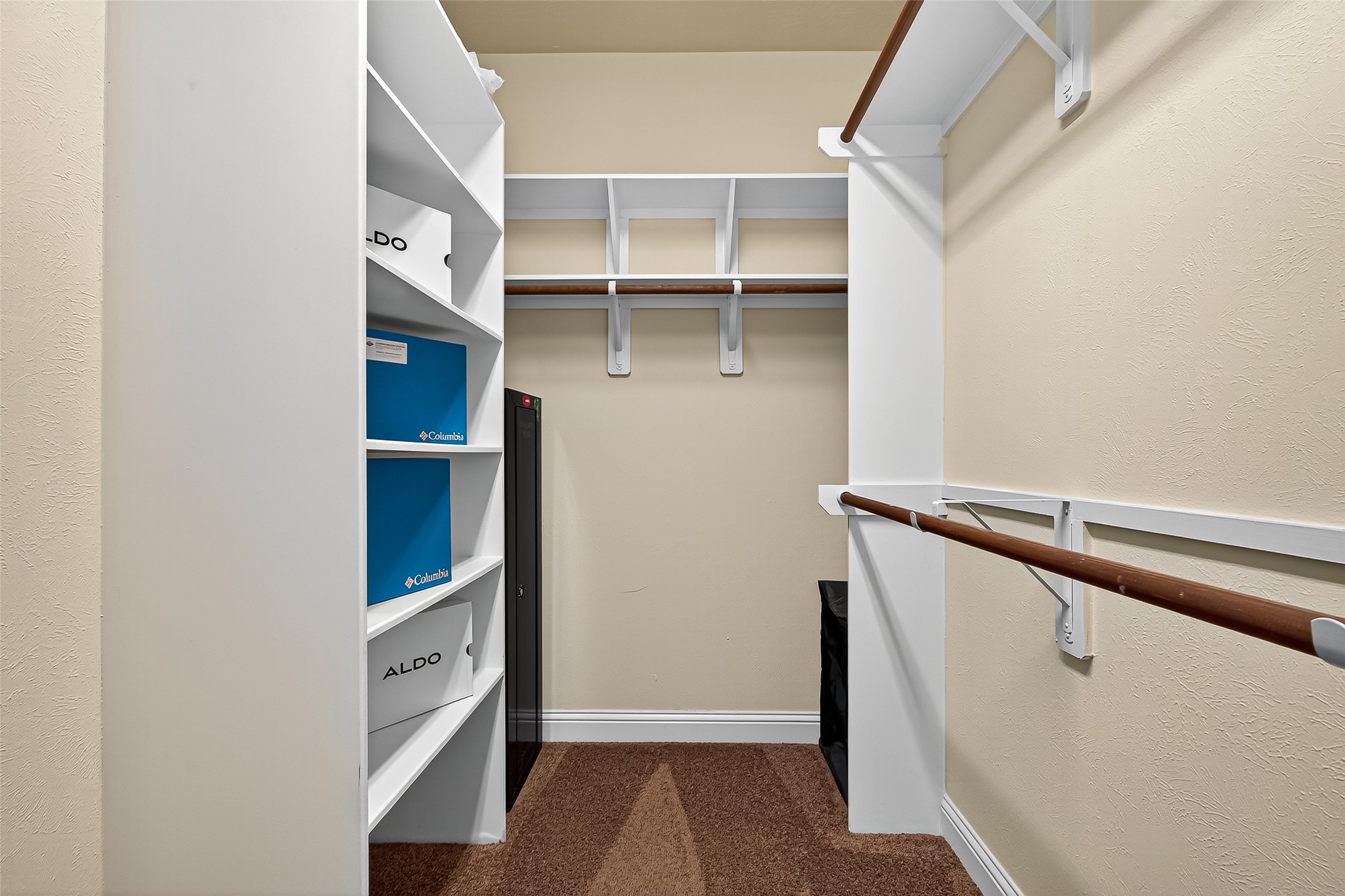 8107 Lockridge Terrace Lane Cypress, TX 77433 - Photo 35 of 50 Spacious and thoughtfully designed, the primary closet offers generous storage with built-in shelving, double hanging rods, and beautiful wood flooring—perfectly blending luxury and practicality.
