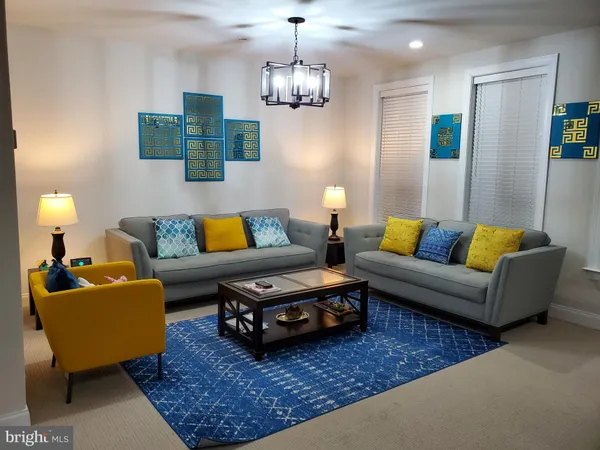 a living room with furniture and a chandelier