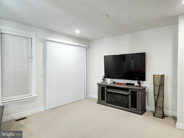 a living room with flat screen tv and a window