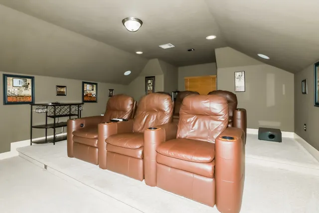 a view of an empty room and chandelier fan